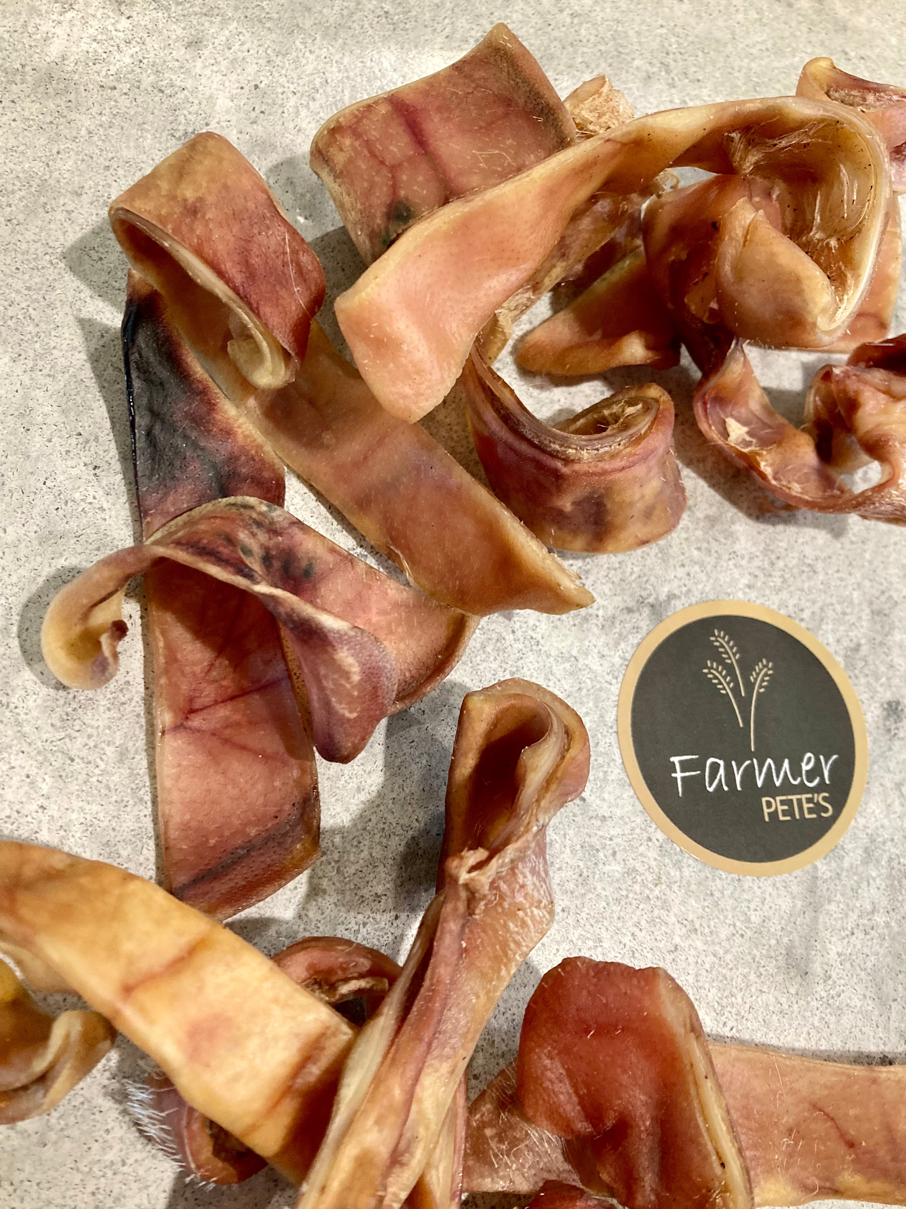 Farmer Pete&#39;s natural pigs ear strip chewy dog treats.