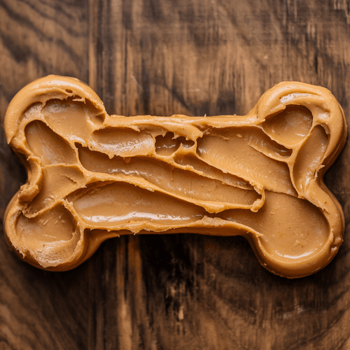 peanut butter dog treat. The treat is in the shape of a bone and is covered in peanut butter. There are dog teeth marks on the treat.