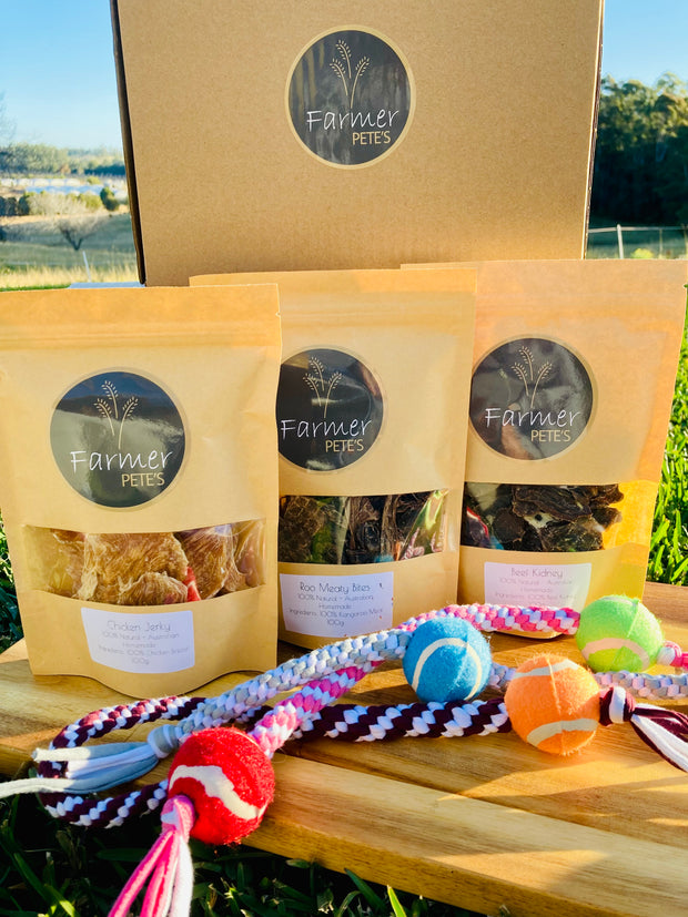 Healthy dehydrated pet treats and handcrafted toys in a gift box by Farmer Pete's.