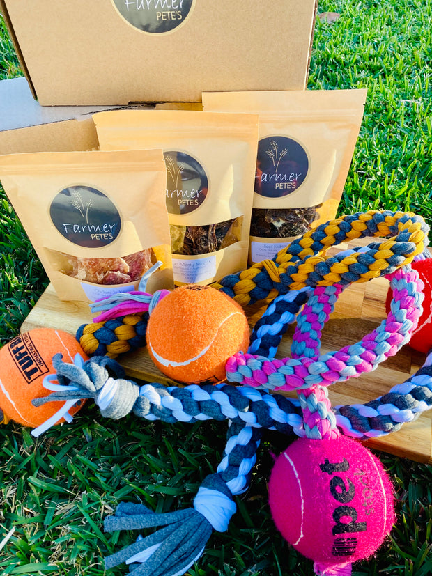 Dehydrated natural pet treats and jumbo handcrafted toy in Farmer Pete's small gift box. 