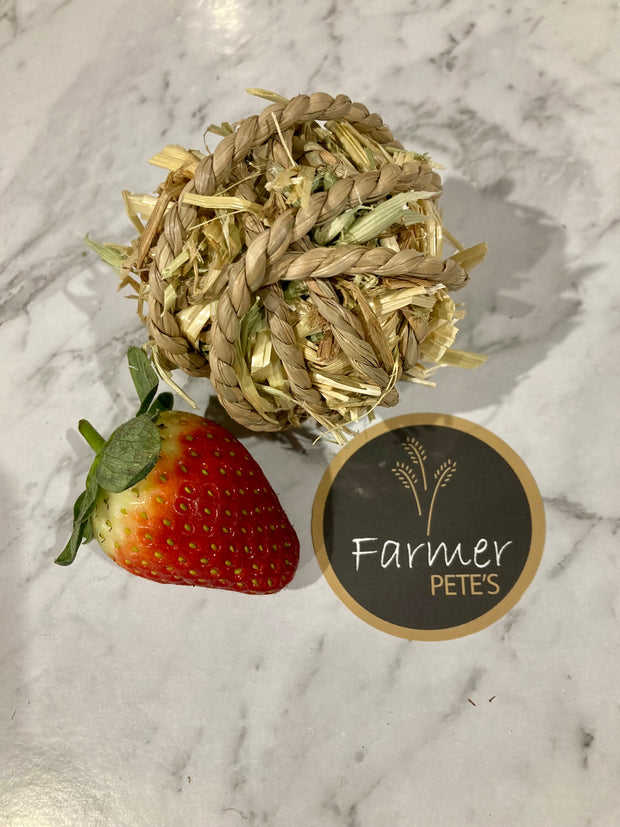 Munchy ball handmade enrichment toy with seagrass twine, oaten hey and Farmer Pete's dehyydrated Rabbit and Guinea pig treats. 