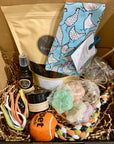 Pamper Your Pooch Box by Farmer Pete's, treats, personalised bandana, paw balm, spritz, paw soaps and a tug toy. 