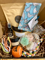 Pamper Your Pooch Box by Farmer Pete's, treats, personalised bandana, paw balm, spritz, paw soaps and a tug toy. 