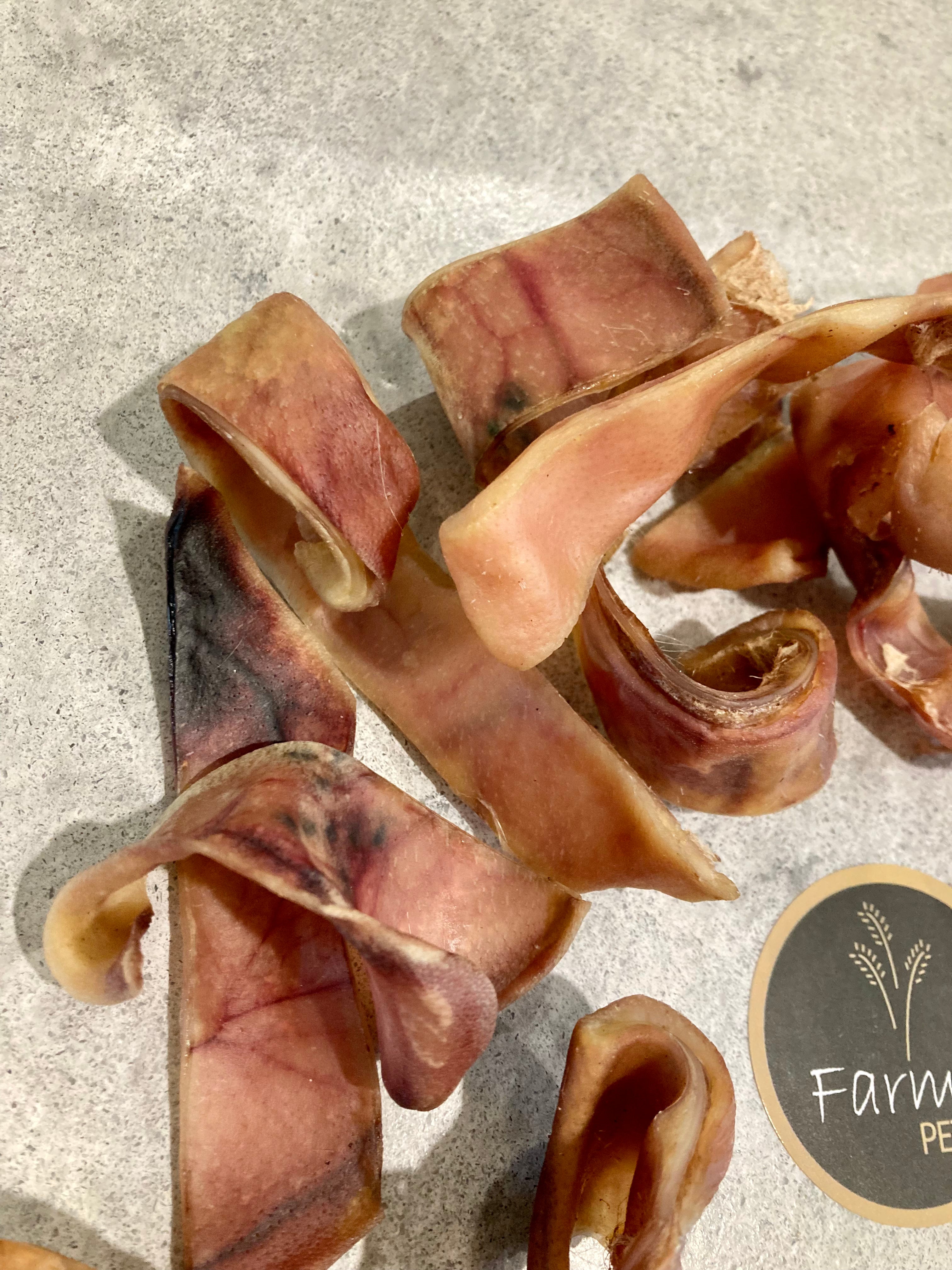 Pigs ear strip chewy treats for dogs by Farmer Pete&#39;s.